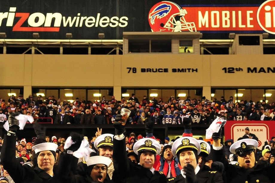 A stadium crowd on its feet at a night game