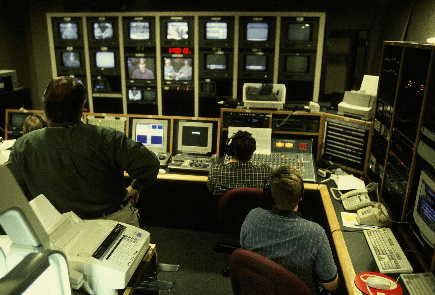 A television control room with a wall of camera monitors