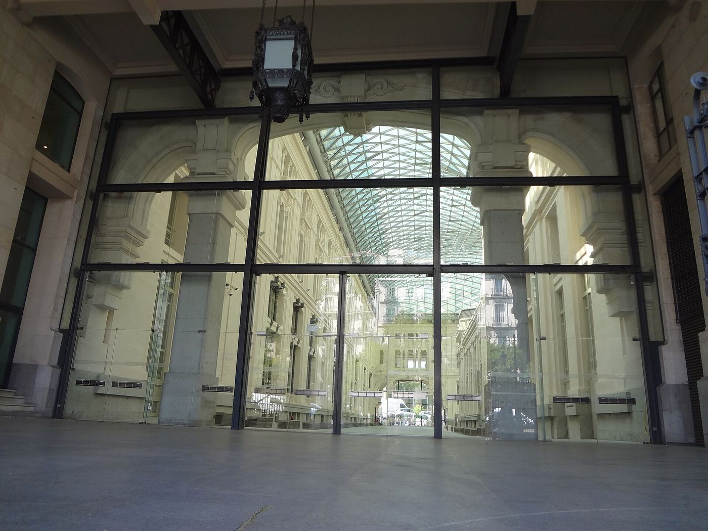 A tall glass wall in a restored post office building in Madrid